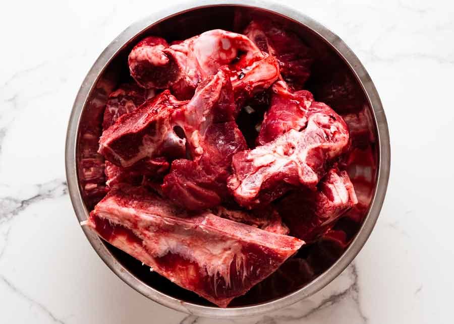 beef-bones-for-beef-stock-in-a-bowl Bowl of raw beef bones for beef stock