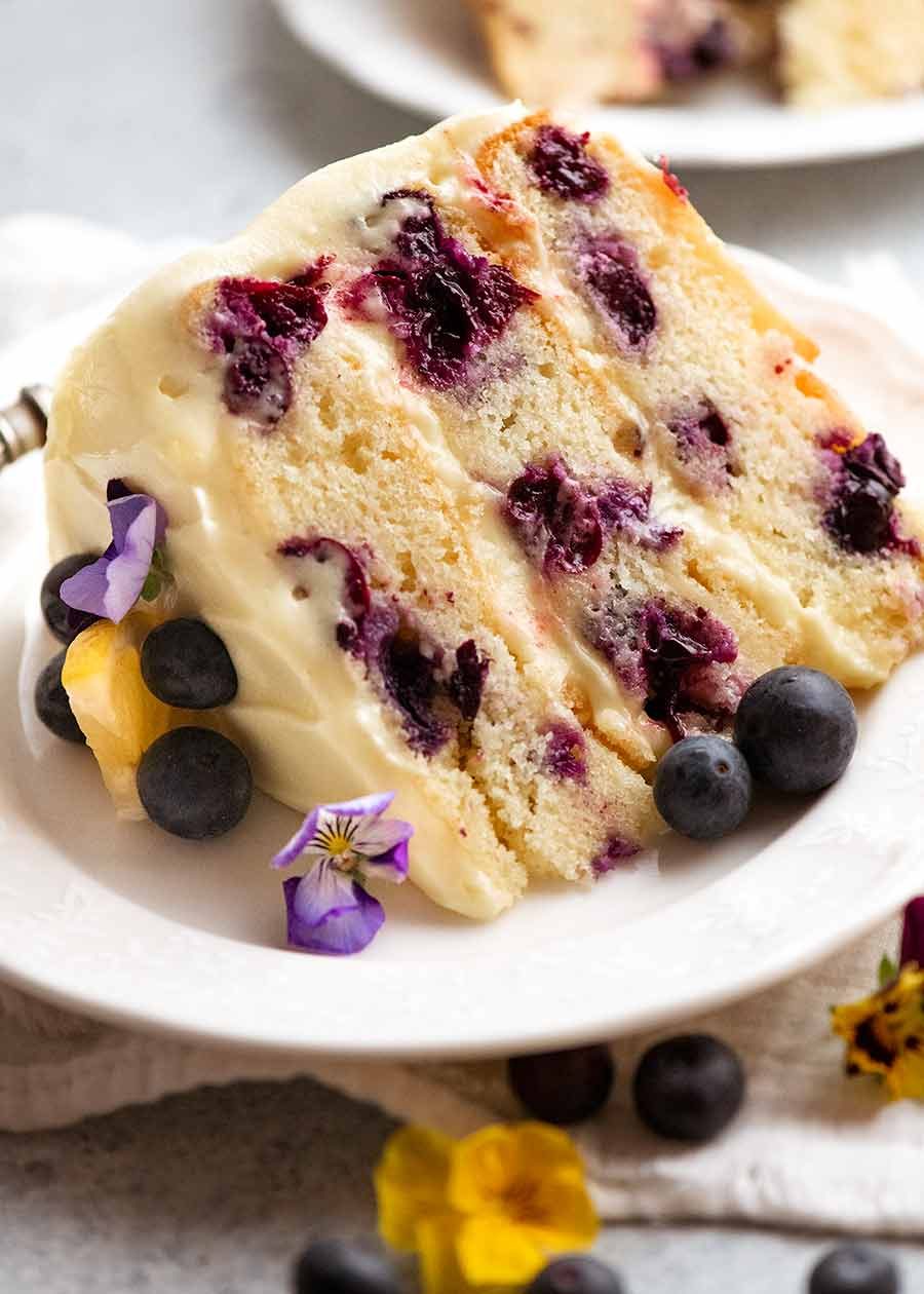 blueberry-cake-with-lemon-cream-cheese-frosting_1 Slice of Blueberry Cake with Lemon Cream Cheese Frosting on a plate