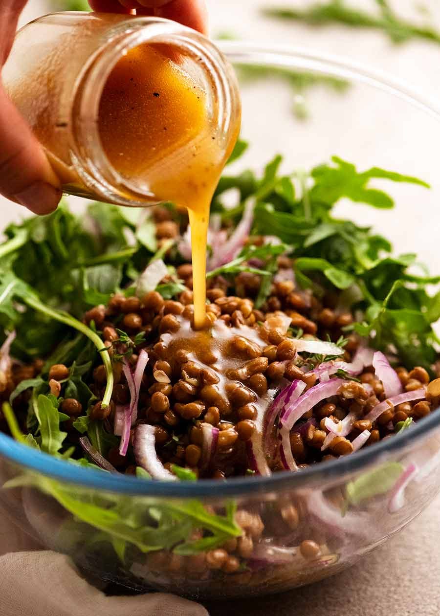 honey-cinnamon-pumpkin-lentil-salad_6 Pouring dressing over Honey Cinnamon Pumpkin Lentil Salad