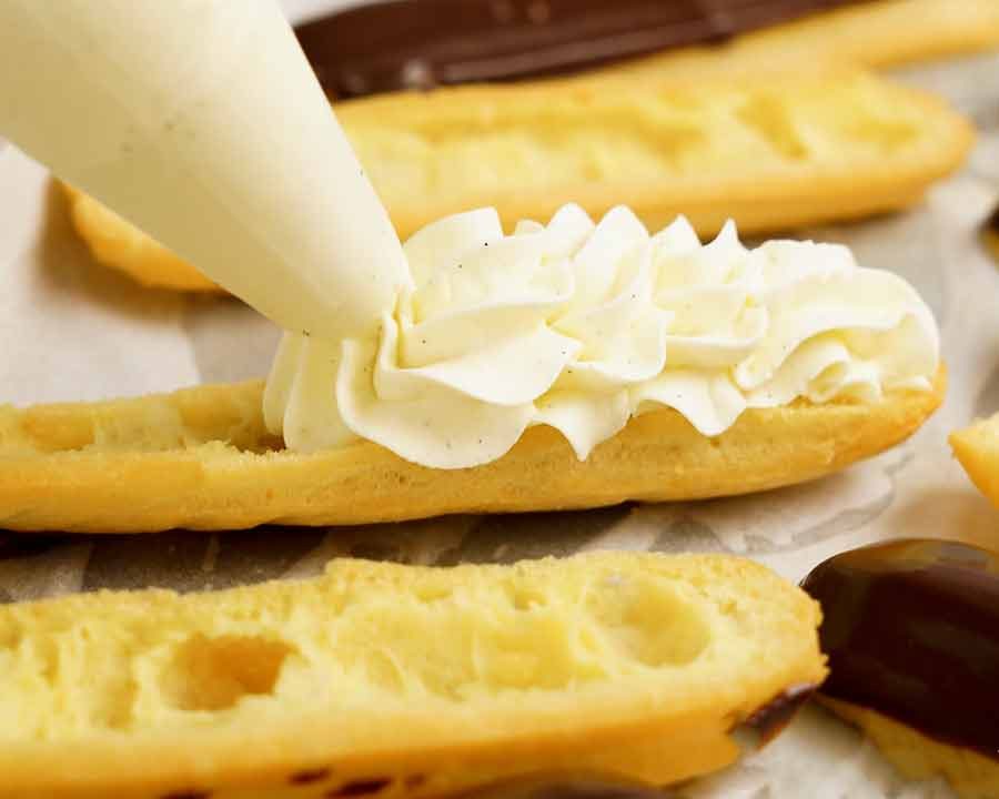 piping-cream-into-eclair Piping whipped cream into an eclair