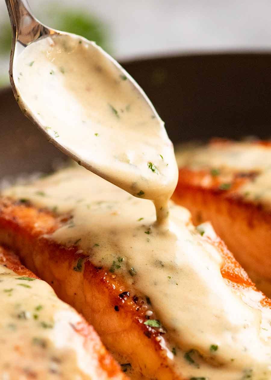 salmon-in-creamy-herb-garlic-sauce_7-copy Drizzling cream Herb & Garlic Salmon Sauce over pan seared salmon