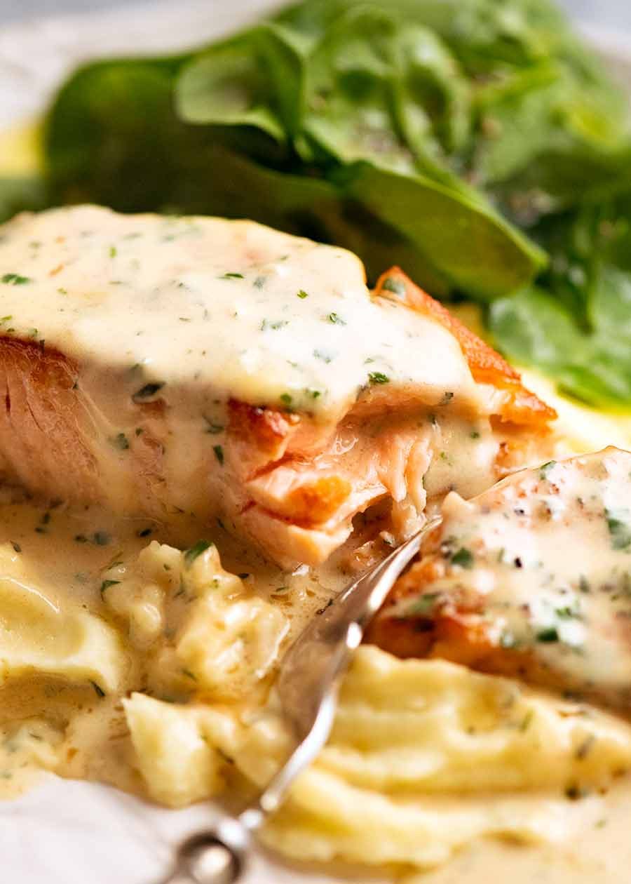 salmon-in-creamy-herb-garlic-sauce_9 Fork cutting into Creamy Herb & Garlic Salmon Sauce
