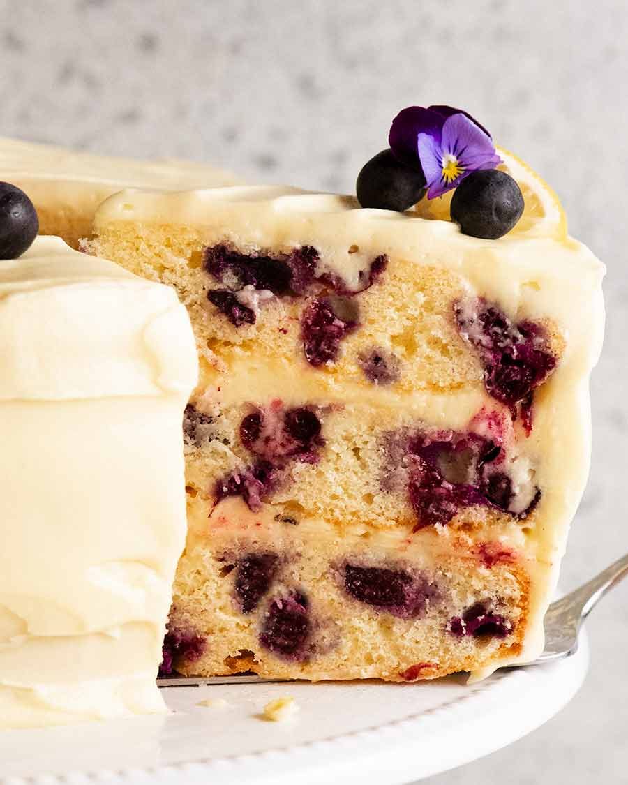slice-of-3-layer-blueberry-cake Slice of Blueberry Cake with Lemon Cream Cheese Frosting on a plate
