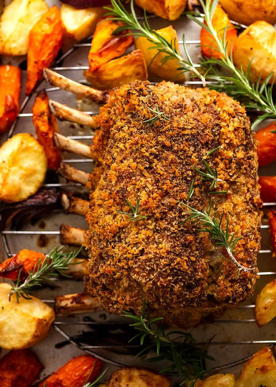 crumbed-rack-of-lamb_1 Rosemary Crumbed Rack of Lamb on a tray, fresh out of the oven, with roasted vegetables