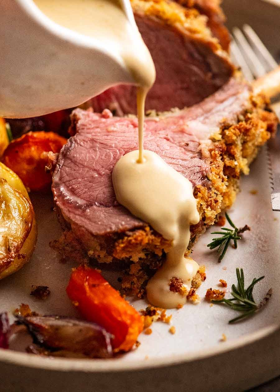 crumbed-rack-of-lamb_9 Pouring Creamy White Wine Mustard Sauce over Rosemary Crumbed Rack of Lamb