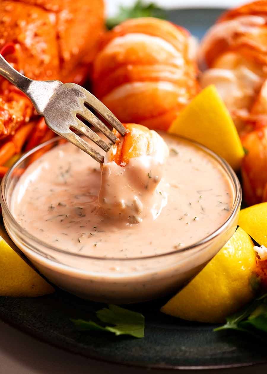 seafood-sauce-with-lobster Dipping lobster into seafood sauce