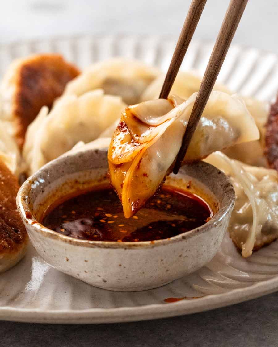 vegetable-dumplings-1_8 Dipping Vegetable Dumplings (Potstickers) in chilli soy dipping sauce