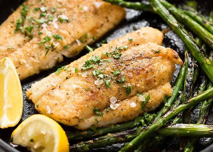 crispy-pan-fried-fish-1-1 Close up of Crispy Pan Fried Fish in a cast iron skillet, fresh off the stove