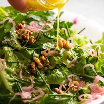 french-bistro-salad_8-sq Drizzling lemon dressing over French Bistro Salad