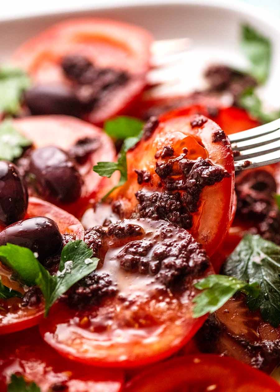 tomato-with-olive-tapenade_7 Fork picking up piece of Tomato Salad with Olive Tapenade