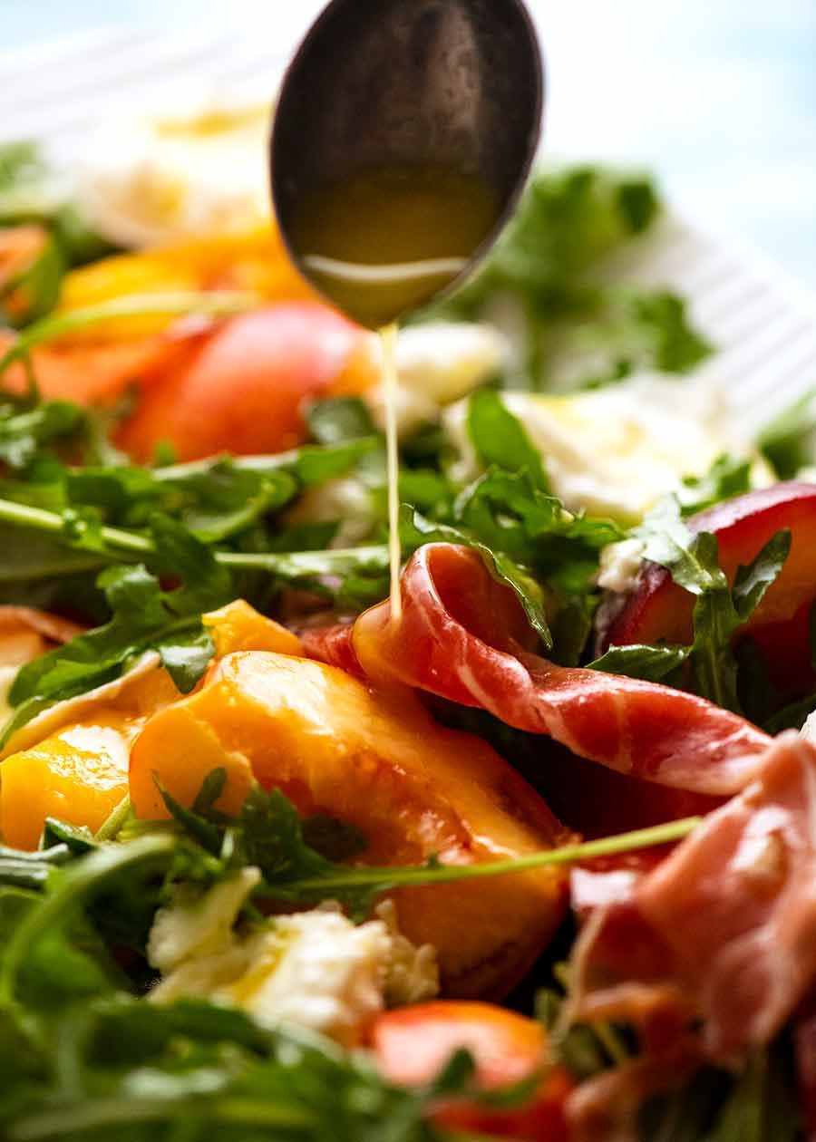peach-salad_1 Drizzling lemon dressing over peach salad