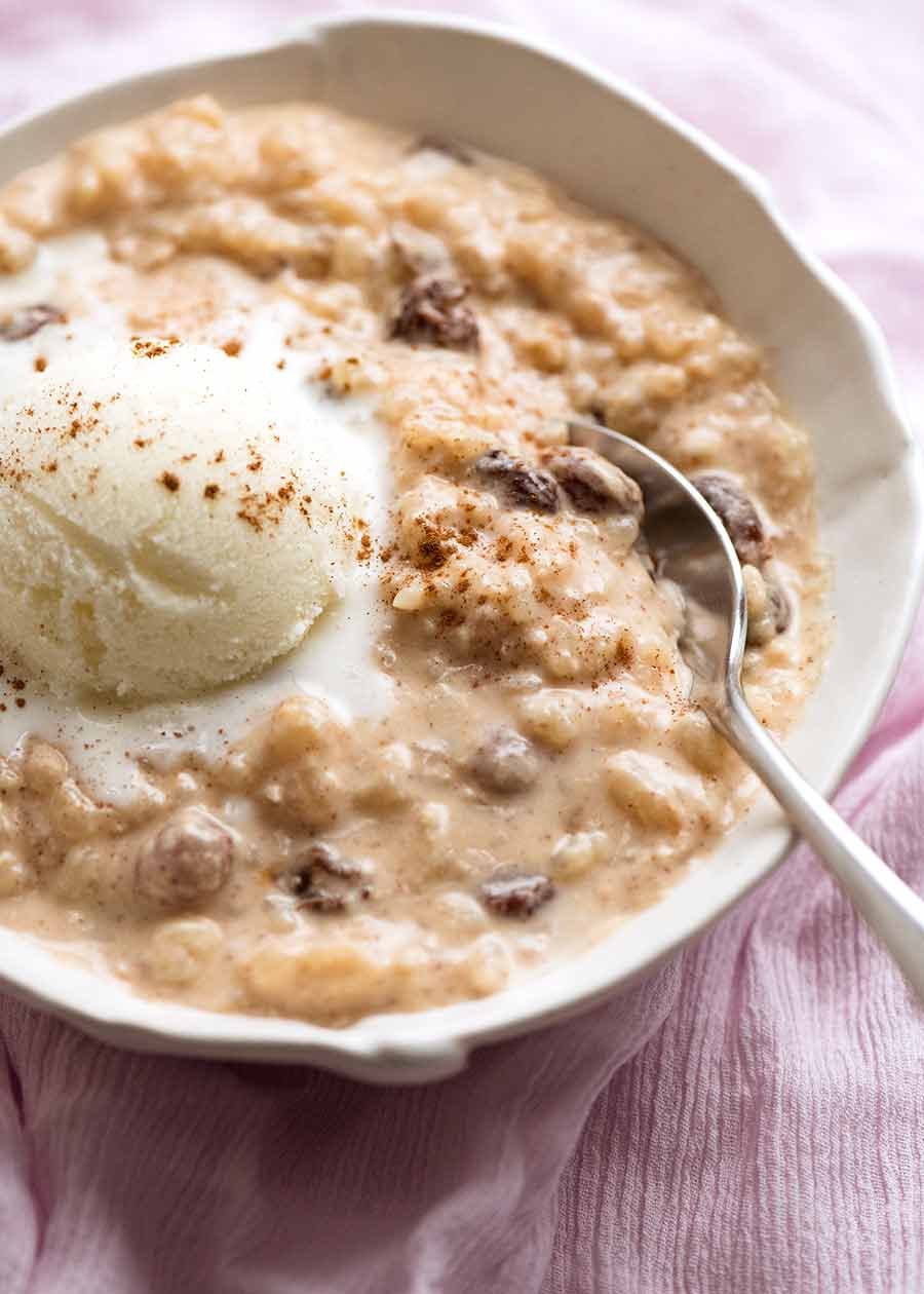 rice-pudding-cinnamon_7 Creamy rice pudding in a bowl with ice cream, ready to be eaten