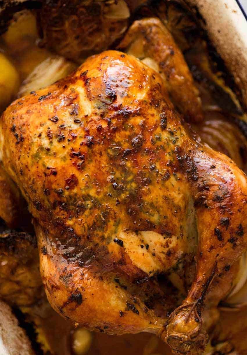 roast-chicken_6a-1 Overhead photo of golden Roast Chicken with crispy skin, fresh out of the oven, bathed in garlic-herb-lemon butter.