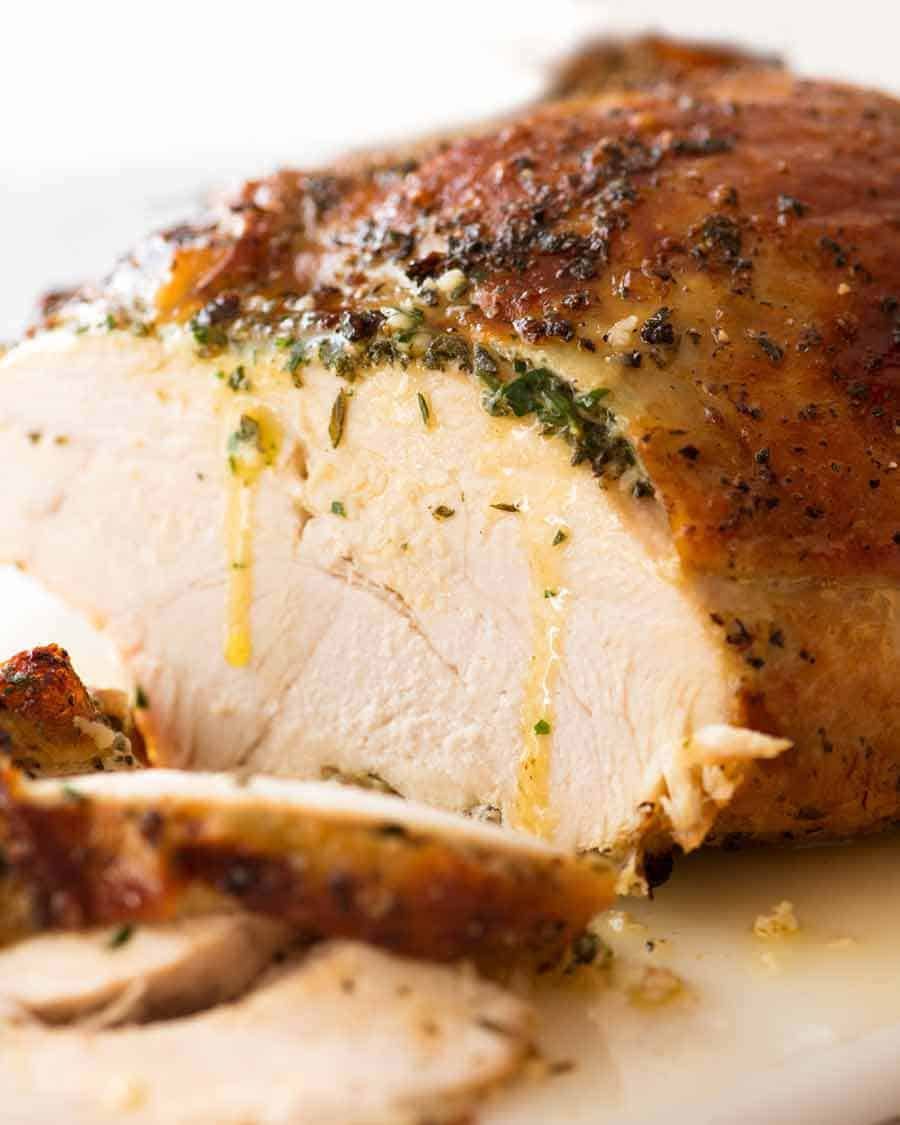 slow-cooker-garlic-herb-turkey-breast Sliced Garlic Herb Slow Cooker Turkey Breast with butter dripping down