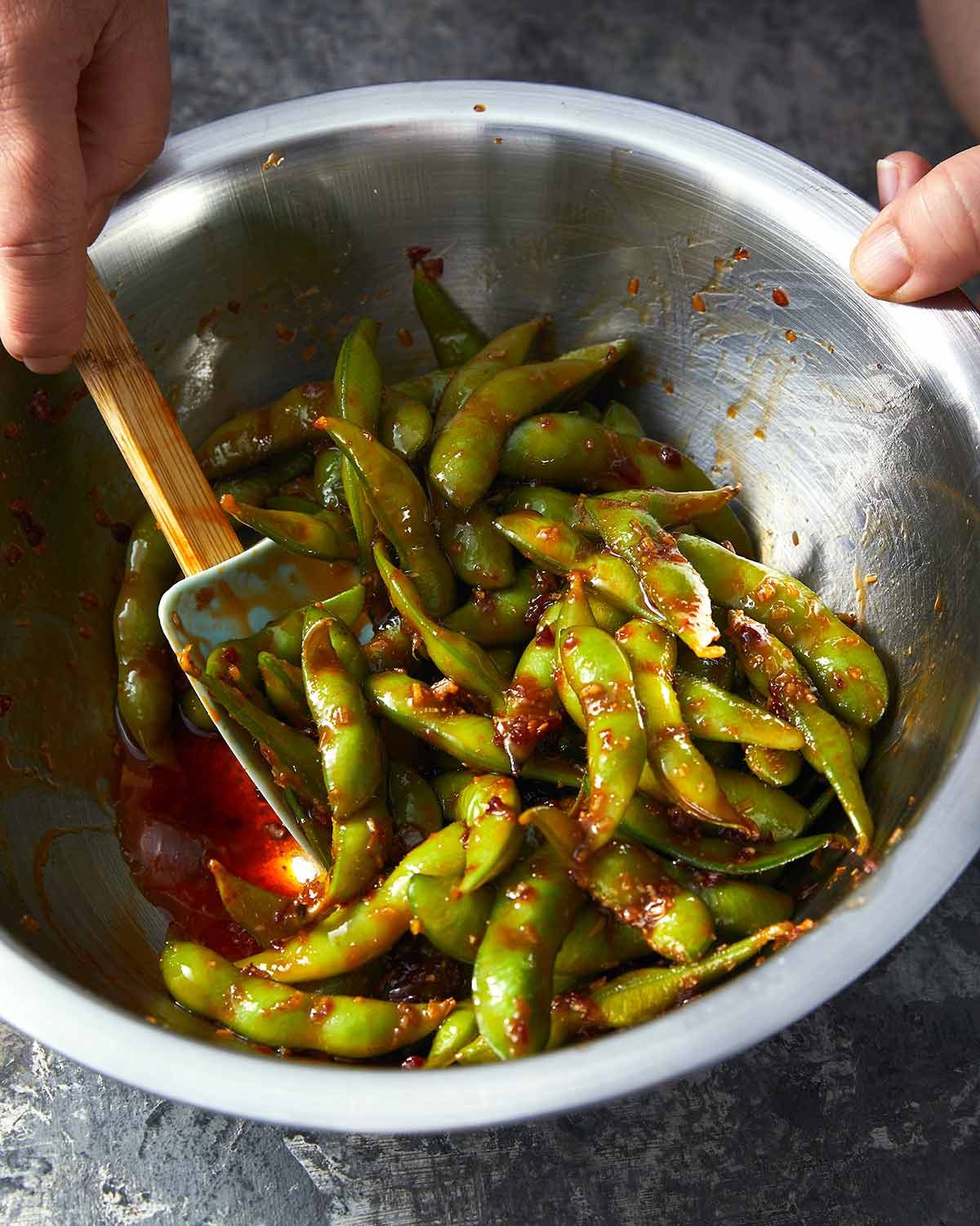 spicy-edamame-47582 Tossing Spicy edamame in a bowl