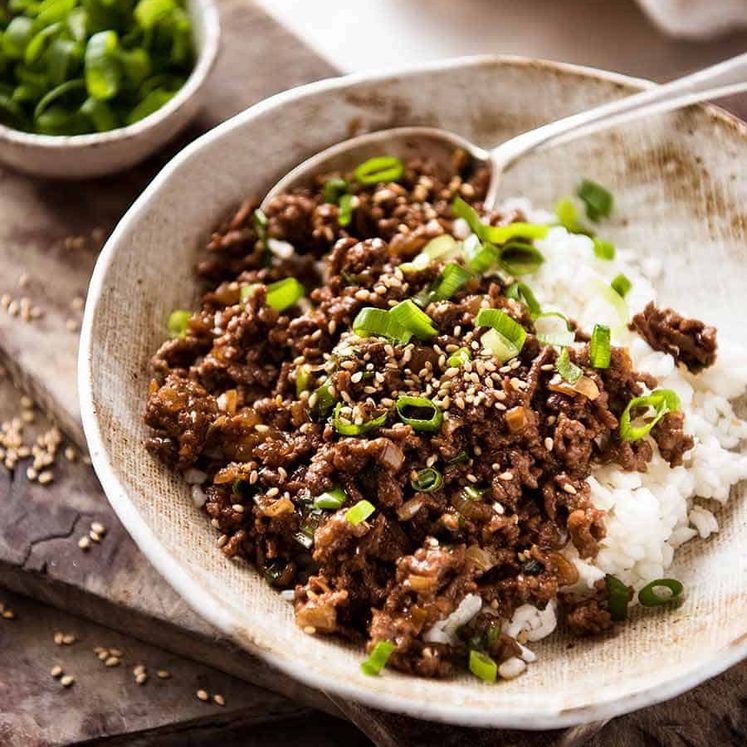 asian-beef-bowls Asian Beef Bowls (ground beef recipe) served over rice garnished with scallions, ready to be eaten