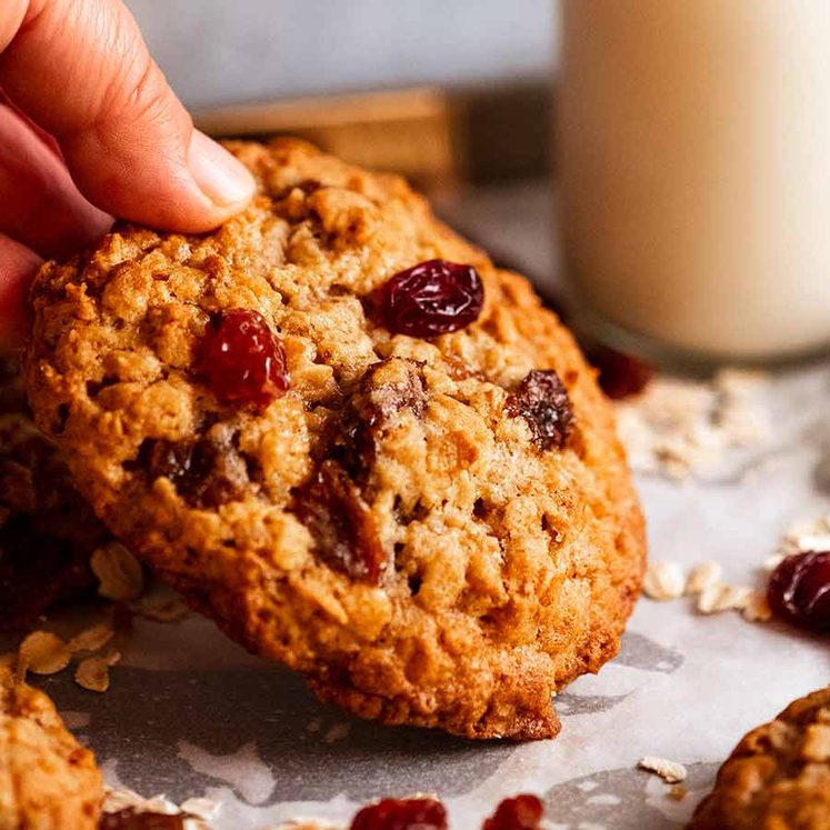 oatmeal-raisin-cookies_3-1 Hand picking up Oatmeal Raisin Cookies