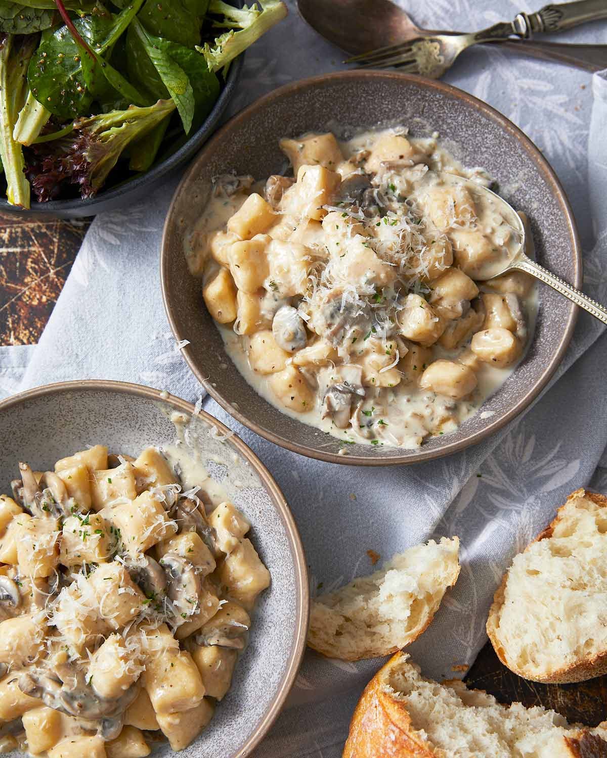 ricotta-gnocchi-51215 Ricotta gnocchi with creamy mushroom sauce in bowls ready to eat