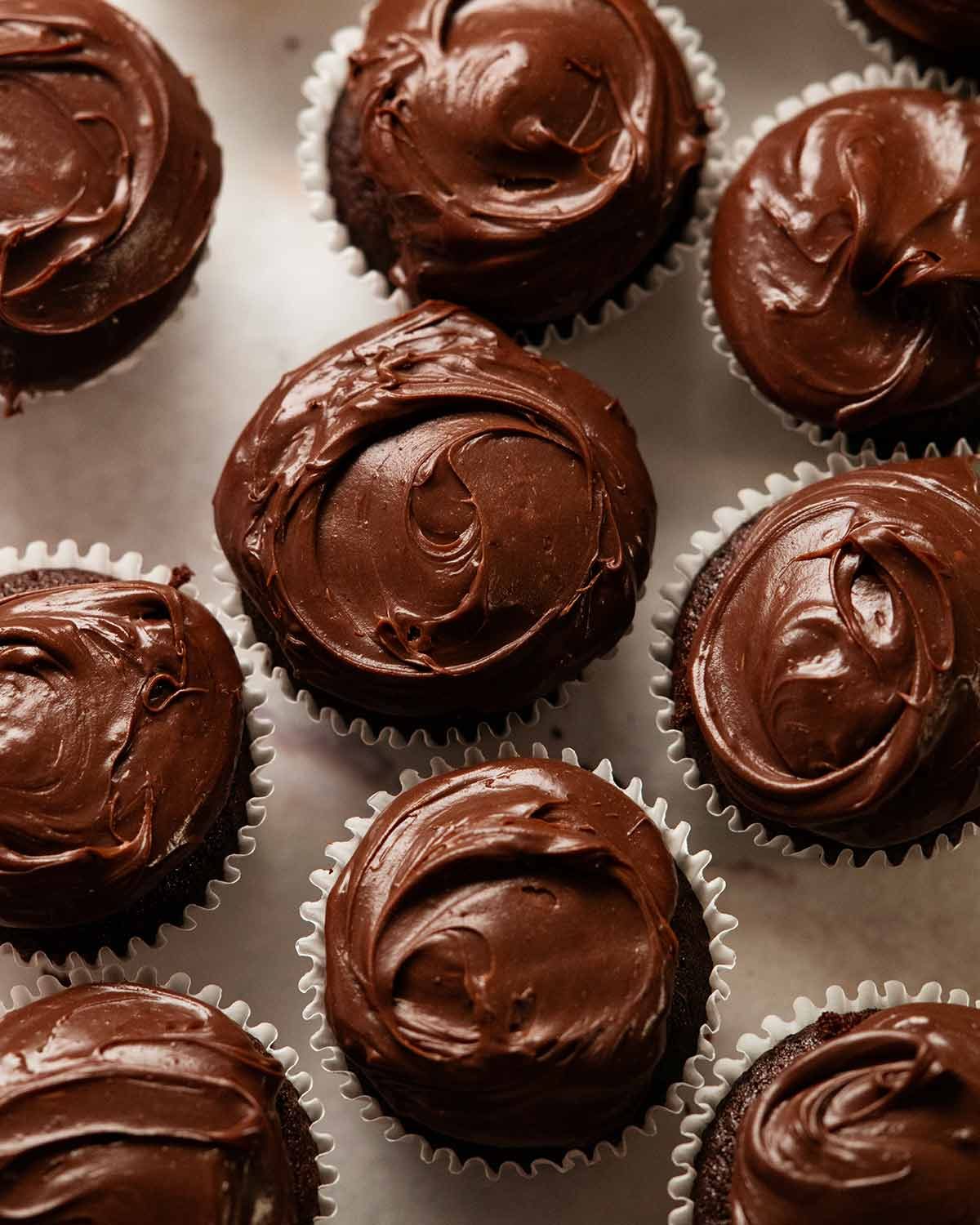 Whipped vanilla cream filled chocolate cupcakes with ganache frosting